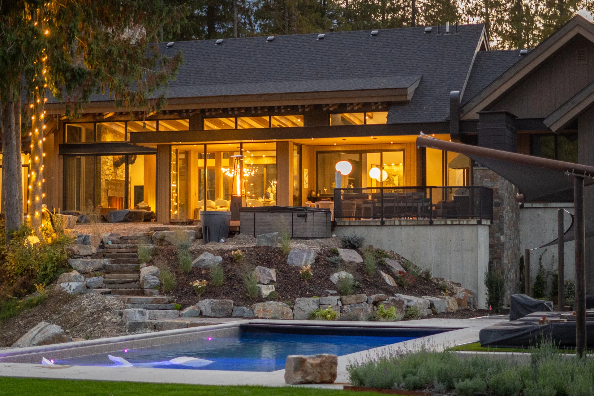 The house and pool lit up at dusk